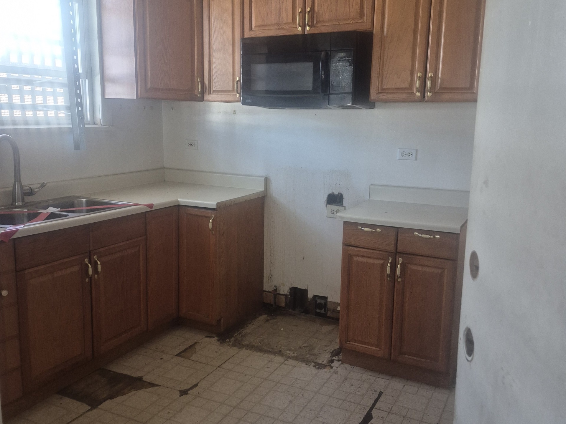 Kitchen rebuild during a unit turn — before